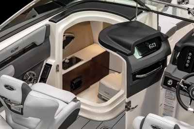 Chaparral 26 SURF head compartment with a sink, toilet, and a portlight. 