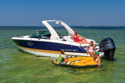 Chaparral 270 OSX beached at a sandbar with a family swimming with an inflatable. 